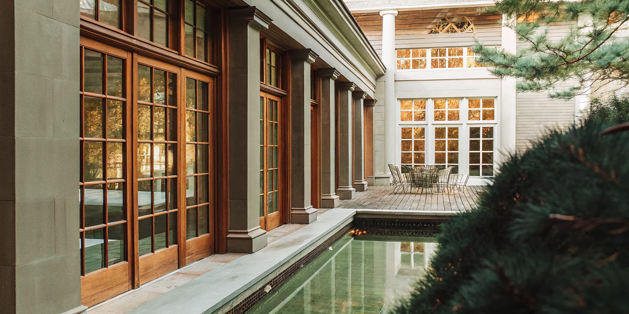 French Chateau-inspired luxury private estate exterior in autumn surrounded by New England foliage