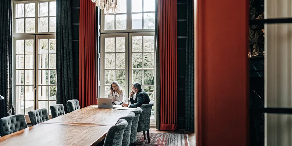Executive leadership team gathered in an elegant private estate for a strategic offsite planning session