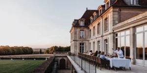Luxurious French chateau estate with outdoor terrace and manicured lawn, ideal for multi-generational family gatherings